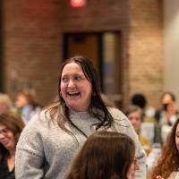 person laughing at luncheon